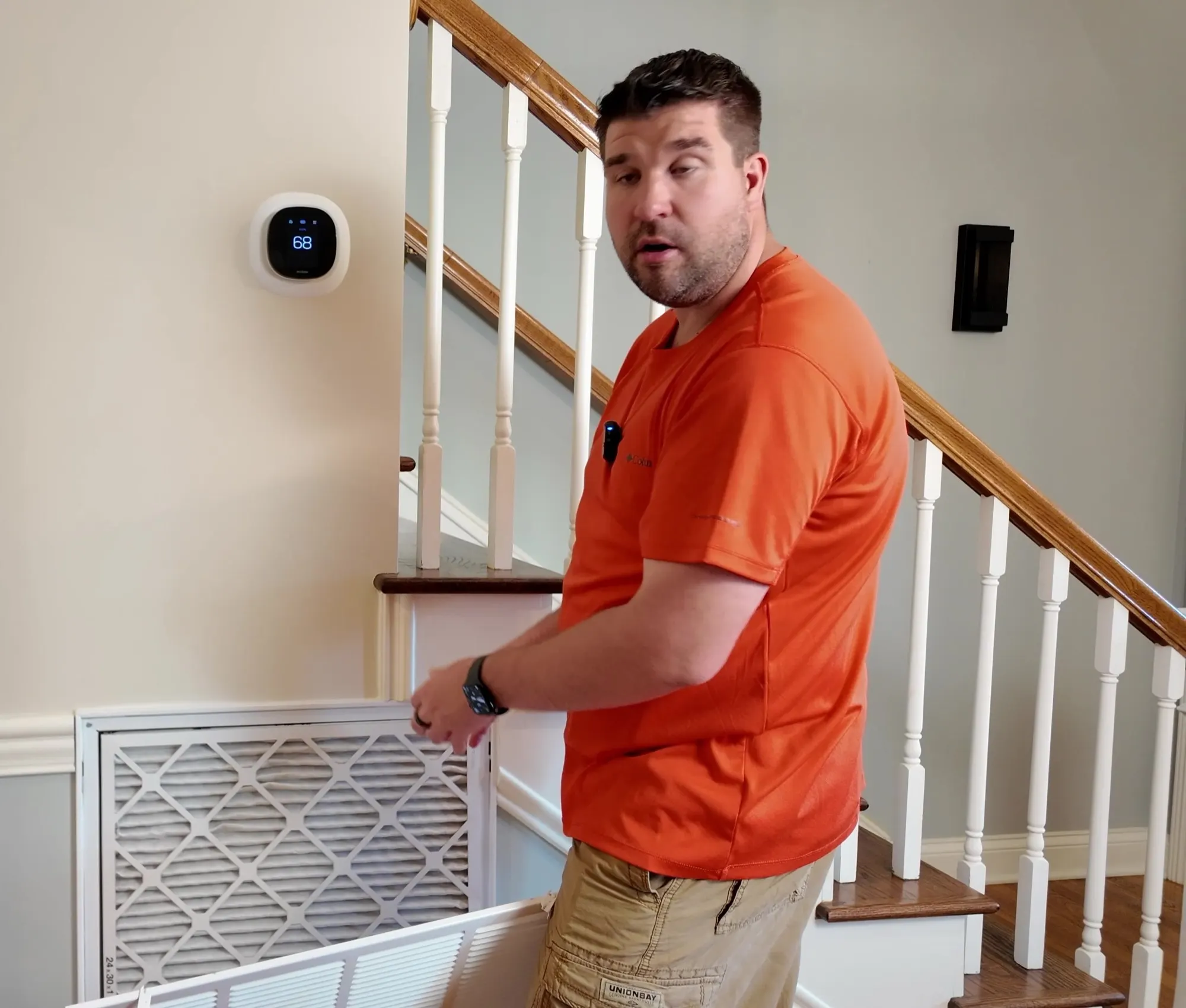 Jeremy at the open return air grille by his stairs, about to change the air filter.